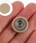 Close-up of a hand holding a beige rivet from 30 Piece Car Headliner Repair Kit With Roof Rivets And Installation Tool For Beige Flannel Car Roof Liner Fix Pins Interior Ceiling Fabric Retainer Clips DIY Friendly Quick Fix