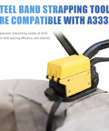 Steel band strapping tool A333 in use with black strapping for secure packaging and stability during banding.