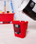 Grab And Go 16 Oz Paint Cup With Magnetic Brush Holder For Trim Work And Touch Ups being filled with white paint