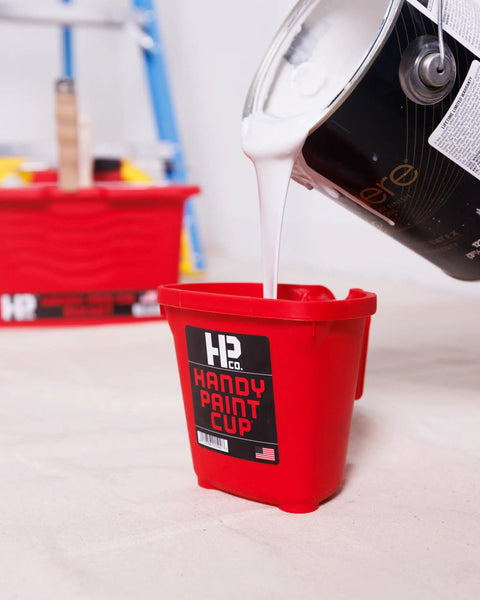 Grab And Go 16 Oz Paint Cup With Magnetic Brush Holder For Trim Work And Touch Ups being filled with white paint
