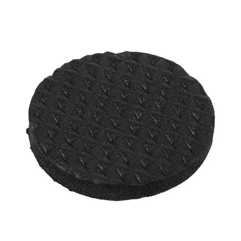 Close-up of a black, textured nonslip rubber foot pad, part of the 30 Piece Black Nonslip Rubber Feet Pads For Durable Floor Protection.