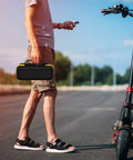 Man holding Premium Heavy Duty Portable Air Compressor Storage Case For Tire Inflator And Charging Cables Dope Protection in yellow.