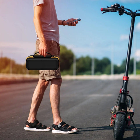 Man holding Premium Heavy Duty Portable Air Compressor Storage Case For Tire Inflator And Charging Cables Dope Protection in yellow.
