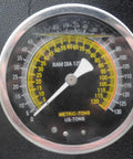 Close-up of precise pressure gauge on Heavy Hitting 75 Ton Air Hydraulic Shop Press with metrics and calibration markings.