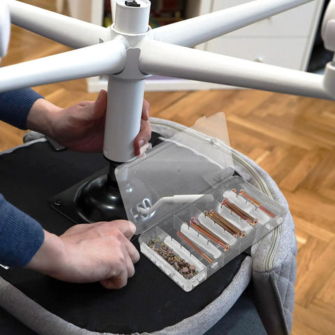 Person using 49 Piece M6 Hex Socket Drive Screws and Barrel Nuts Set for chair assembly, showing metal fasteners and tools