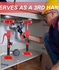 Cabinet jacks side view: two red adjustable jacks with black posts under a cabinet for upper cabinet installation.