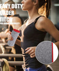 Woman holding Five Pack Quick Dry Microfiber Gym Towel, heavy duty stitching, grey 16x27 inches, in gym environment.