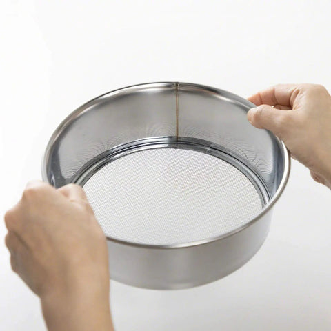 Hands holding a 3-Piece Pro-Grade Soil Sieve Set For Bonsai And Garden Projects, 8.25 Inch Stainless Frame with interchangeable mesh lids.