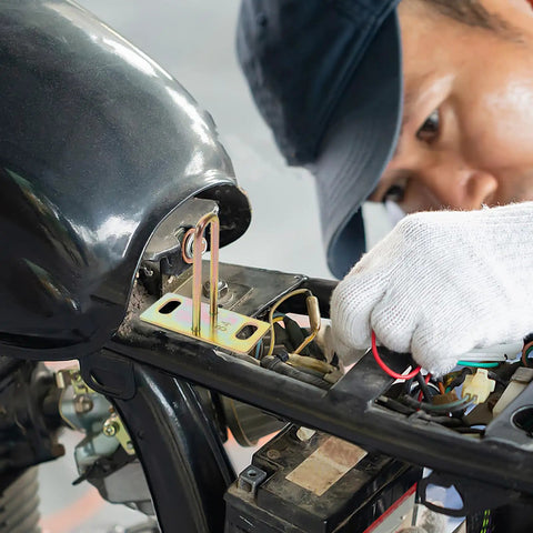 Mechanic working on motorcycle showing installation of 4 Pack Metal Electric Bike Seat Lock Hooks For Electric Bikes And Scooters