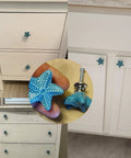Four Pack Starfish Drawer Knobs Set, Coastal Ceramic Cabinet Hardware In Ocean Blue, Durable Zinc Alloy And Ceramic Build, Beachy Ocean Vibe Themed Kitchen Dresser Drawer Knobs For Cabinets. 34 mm starfish knob on white cabinet