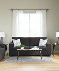 Living room with Shavontae Modern Table Lamps Set Of 2 27.5 Inch Gray Resin Bases and White Fabric Drum Shades on end tables.