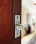 Close-up of Smooth Operator Passage Door Latch with satin nickel finish on wooden door, showcasing adjustable spindle design.