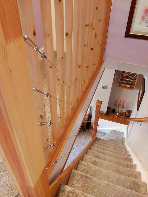 M5 Turnbuckle Kit For One Eighth Inch Cable Railing And Wood Posts installed on indoor staircase