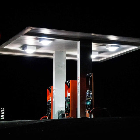 Night view of a gas station canopy illuminated by 80W LED Canopy Light Outdoor Delivers 9600 Lumens Of Daylight 5000K Brightness For Garages