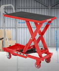 Heavy-duty hydraulic lift table cart in red with black non-slip top, 32-inch lifting height, and locking wheels.