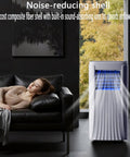 No Sweat Portable Air Conditioner And Swamp Cooler With Remote Control and 1L Tank in living room, providing quiet airflow next to sofa.