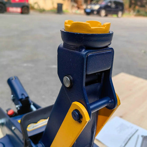 Close-up of Ultra Low Profile Hydraulic Floor Jack With 2 Ton Capacity And 4000 Lbs Lift, steel arm detail outdoors.