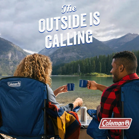 Two people in camping chairs by a lake with mugs, surrounded by mountains and forest. Coleman logo on chair. Text reads 'The Outside is Calling.'