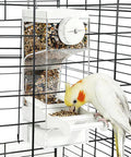 No Sweat Semi Enclosed Automatic Bird Feeder With Generous Fifty Ml Seed Stash For Parrots Canaries And Cockatiels, mounted and filled with seeds.