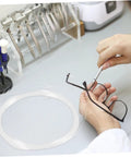 Person repairing glasses using a Glasses Repair Thread Kit For Half Frame Eyewear Lanyard And Wire Repair Tool with stainless steel thread.