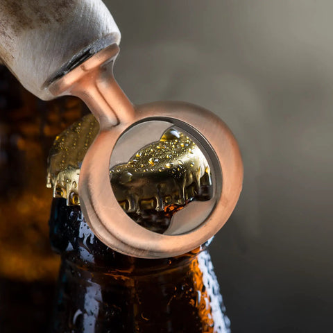 Solid bronze bottle opener lifting a beer cap, showcasing 7 Piece Bulk Metal Bottle Opener Inserts And Blanks For Wood Turning DIY Craft Projects Solid Bronze Threaded Beer Hardware Parts Ready To Whip Up Some Sick Custom Gear And Wedding Favors.