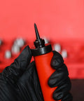 Close-up of hand in glove holding punch tool from Pro Grade Hollow Punch Kit For Leather And Gasket Making, 13-in-1 Hole Punch Set.