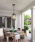 Modern Outdoor Pendant Light With Rock Solid Aluminum Build And Clear Glass Panel, hanging in a covered patio dining area.