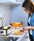 Woman slicing lemons near 10 Pack Dual USB Wall Outlet With 5.0A Fast Charging Ports, stainless toaster on counter