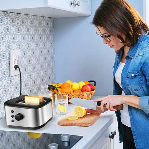 Woman slicing lemons near 10 Pack Dual USB Wall Outlet With 5.0A Fast Charging Ports, stainless toaster on counter