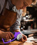 User cutting leather with Heavy Duty Cordless Electric Scissors 4V Rechargeable Rotary Cutter for crafts.