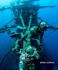 Diver in camo wetsuit wearing a Slick Frameless Dive Mask With Mount For All GoPro Hero Cameras for scuba diving near shipwreck