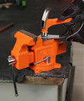 Heavy Duty 5 Inch Bench Vise With Swivel Base And Anvil, Multi Jaw Clamp for Woodworking, shown on a workbench