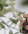Hand using Outdoor Misting Nozzles Set, Stainless Steel High-Pressure Fogger Heads, Anti Drip and Cleanable Design, spraying water.