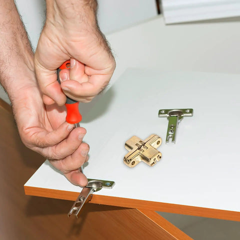 Hand installing Hidden Cross Zinc Alloy Concealed Hinges Two Pack for wooden doors and lightweight worktops