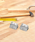 Heavy Duty Stainless Steel Spring Door Hinges 10 Pack for Outdoor Wood Doors and Cabinets Built Tough All Weather Durability Adjustable Spring Tension Easy Install Weatherproof Silver Hinges, two silver hinges on wood workbench