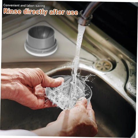 Hands rinsing the Premium Portable Electric Citrus Juicer's detachable cup under running water in a sink.