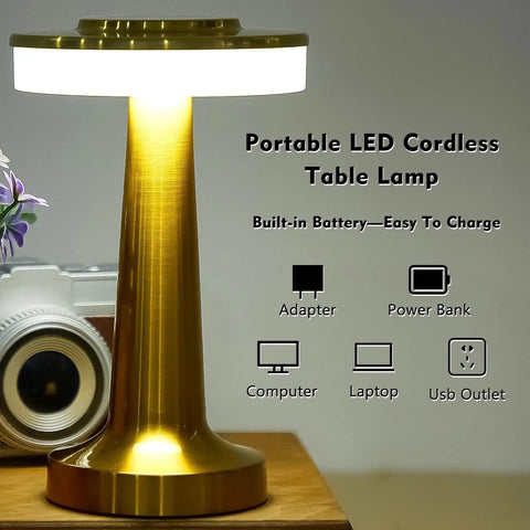 Two Pack LED Portable Cordless Table Lamps With Touch Sensor, Gold lamp on wooden surface with charging options shown.