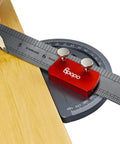 Rock Solid Stainless Steel Angle Protractor With Dead Accurate 0 To 180 Degree Readings For Woodworking Bench Projects Plus Integrated Straight Edge Marking Ruler measuring on a wooden surface.