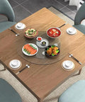 Premium Tempered Glass Lazy Susan Turntable Serving Tray For Dining Tables And Party Crews Featuring Silky Swivel Spin And No Sweat Washup At Thirty Four Inches Across on a wooden table with various dishes.