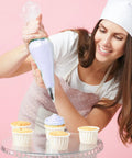 Next Level Cake Decorating Kit Featuring Hella Durable Anti Burst Piping Bags Stainless Steel Frosting Tips Set And Reusable Pastry Supplies For Baking Like A Champ Zero Worries, woman using piping bag on cupcakes.