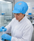 Five Pack Blue Anti Static Caps Featuring Breathable Mesh Panels And Reliable Dust Blocking Defense For Cleanrooms Laboratories And Industrial Shop Grind Heavy Duty Headwear Engineered To Keep You Cool And Confident On The Daily worn by a lab worker in a cleanroom.