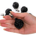 Six Pack Black Tablecloth Weights With Resin Round Ball Hangers And Metal Clips Heavy Duty Cloth Clips held in hand