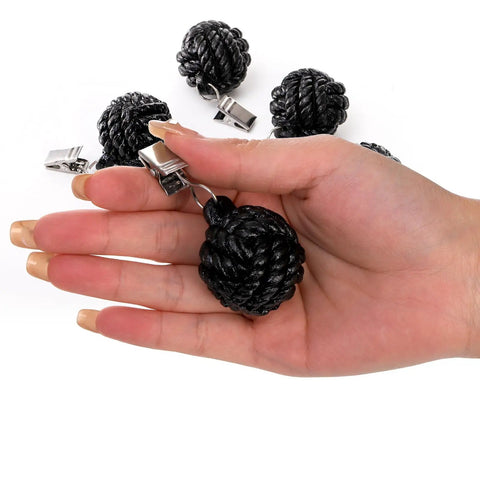 Six Pack Black Tablecloth Weights With Resin Round Ball Hangers And Metal Clips Heavy Duty Cloth Clips held in hand