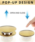 Hand demonstrating the open and close mechanism of a pop-up drain with a golden finish for freestanding tubs.
