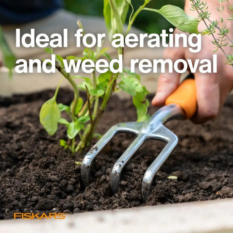 Ergo Cultivator For Digging And Aerating Soil And Weeding This Heavy Duty Garden Tool shown aerating soil near plants