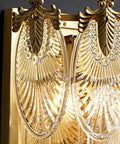 Close-up of Top Shelf Modern Copper Wall Sconce With Super Soft Glass Shade displaying intricate gold and clear glass design.