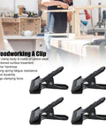 Set Of 4 Heavy Duty Wide Mouth Metal Spring Clamps For Woodworking And Diy Projects Great For Photography Backdrops Bonding Panels Hanging Fabric Papers And Small Fixtures Built From High Hardness Carbon Steel on display with workshop background.