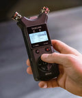 Pro On The Go Grab And Go 32 Bit Float Field Recorder With USB C Audio Interface in hand, showing adjustable condenser mics.