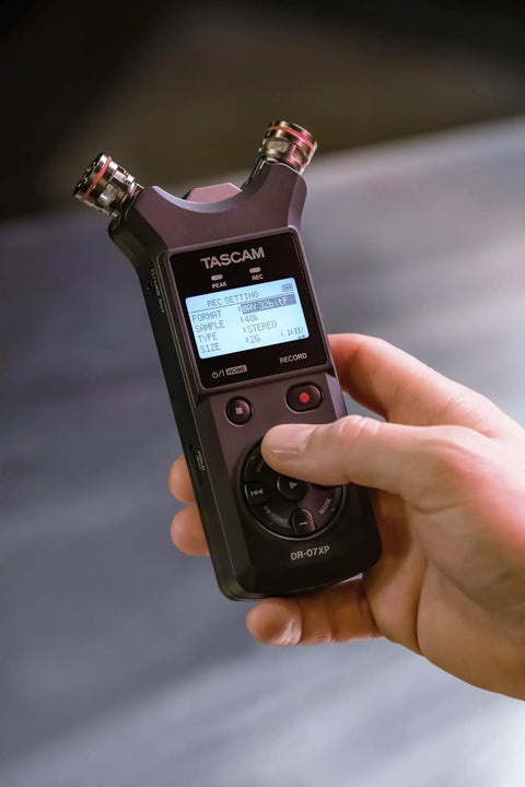Pro On The Go Grab And Go 32 Bit Float Field Recorder With USB C Audio Interface in hand, showing adjustable condenser mics.