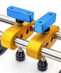 Stone seam setter tool with two blue vacuum suction blocks mounted on yellow clamps around a chrome rod.
